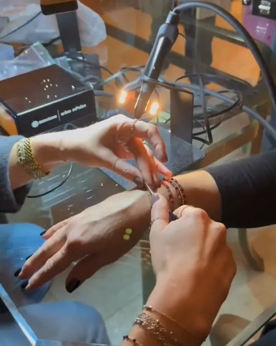 Real Auburn Jewelry ad: a bracelet being welded on at a private party
